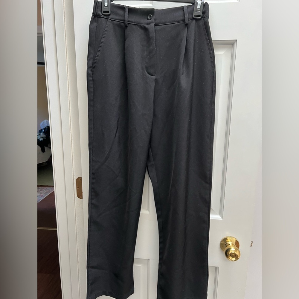 Black slacks with front pleats